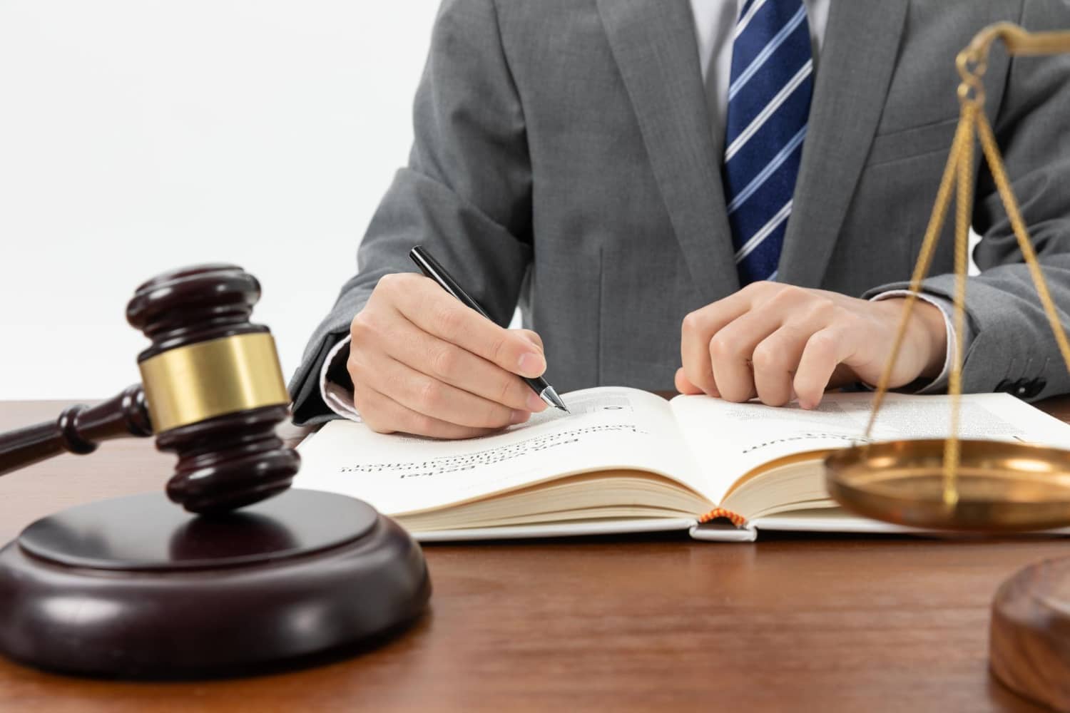 Closeup Shot Person Writing Book With Gavel Table 1