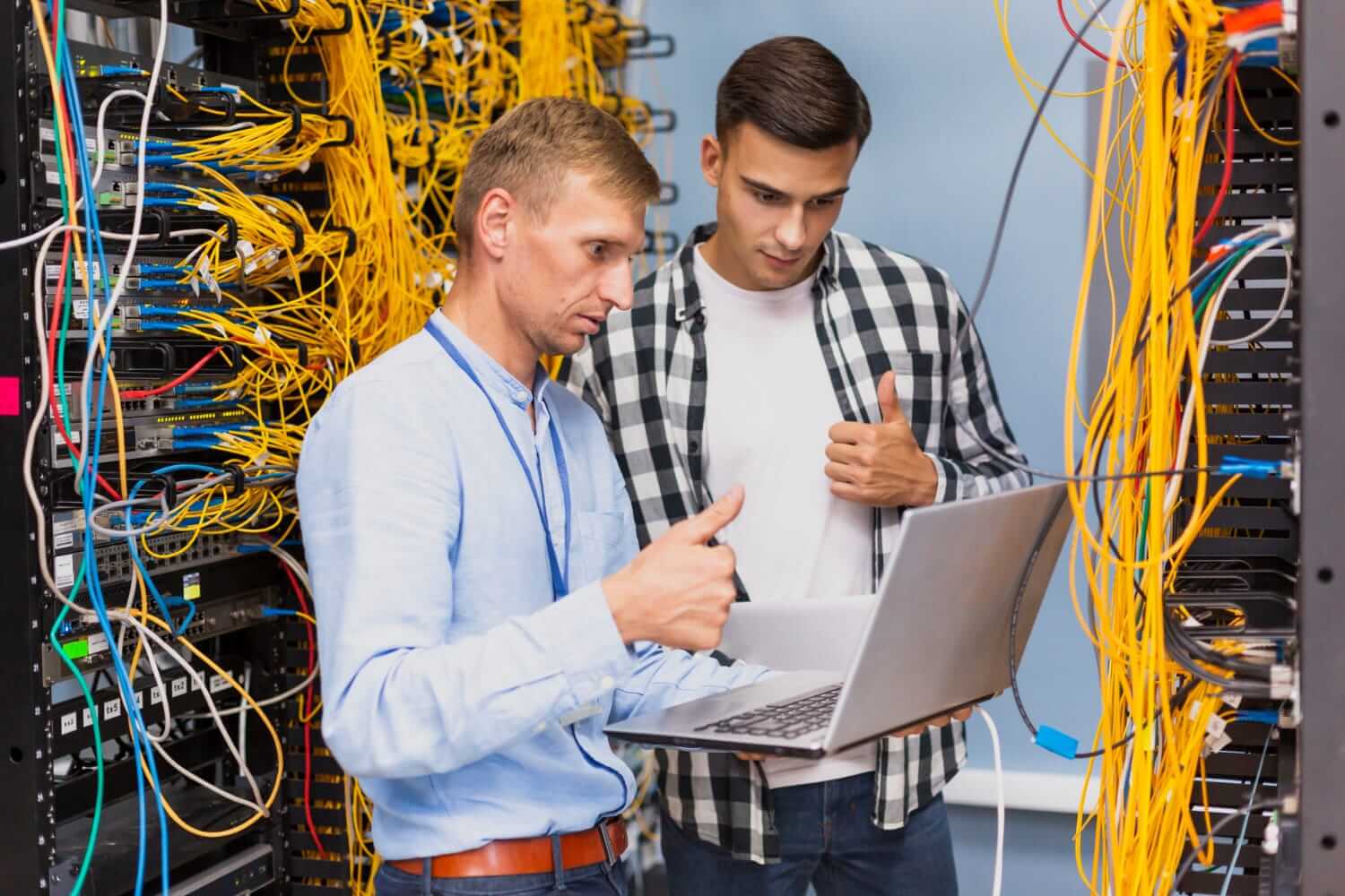 Young Network Engineers With Laptop Medium Shot (1) (1)